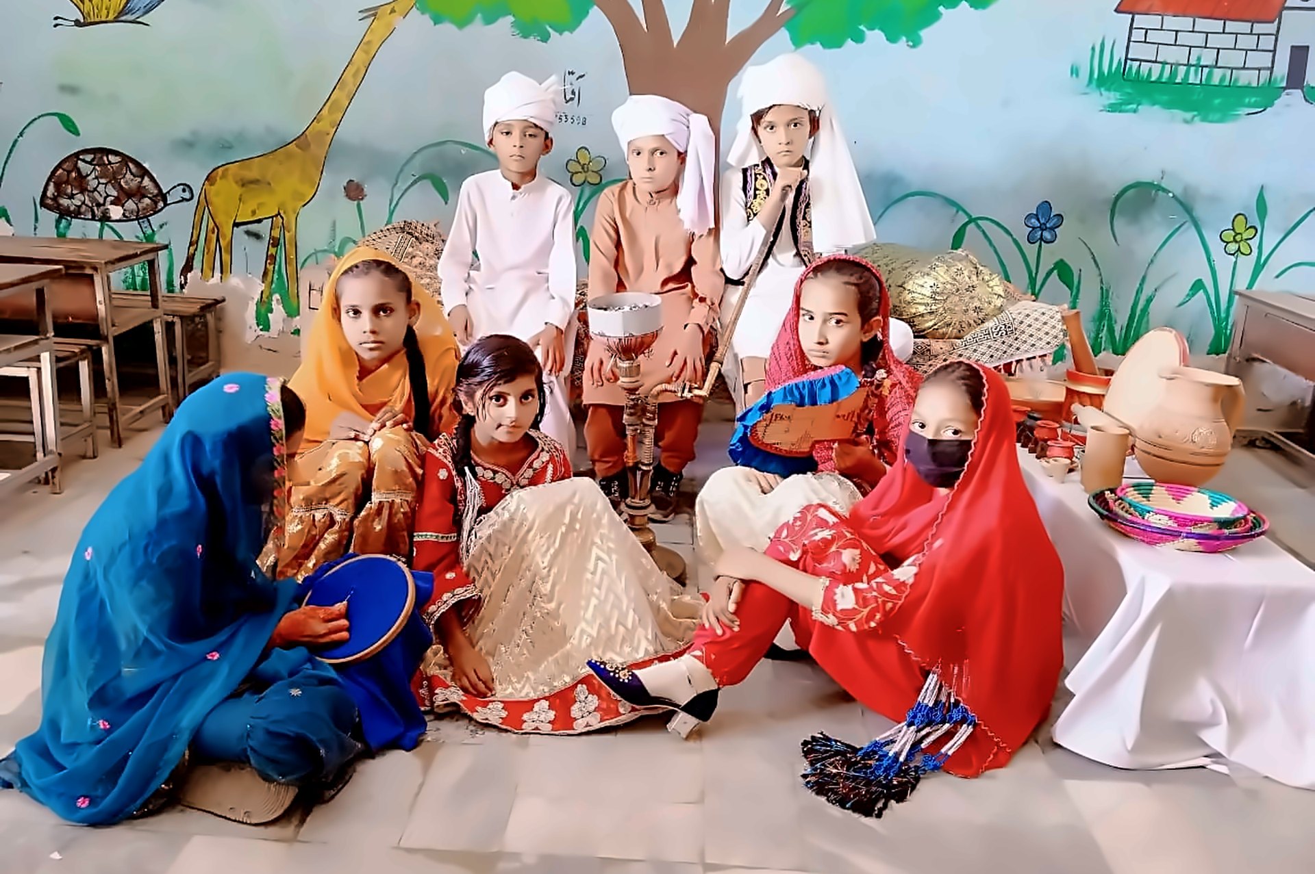 Students in traditional dress with handicrafts at a cultural day in a PDO-managed school