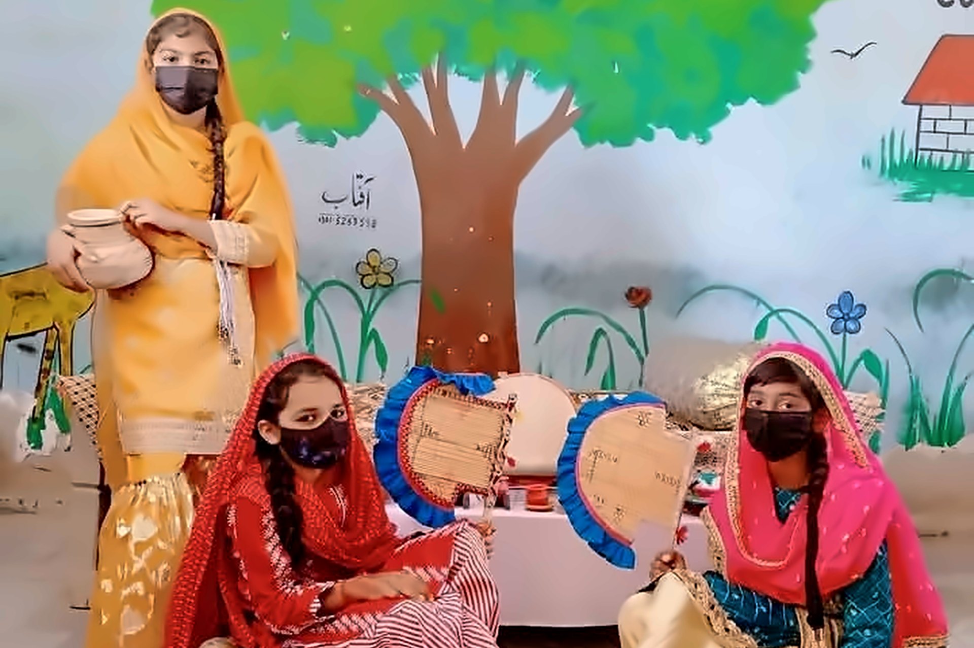 Students in traditional dress with handmade fans